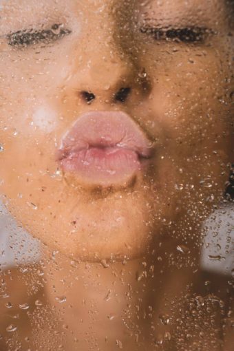 A person giving a kiss showing off their full lips.