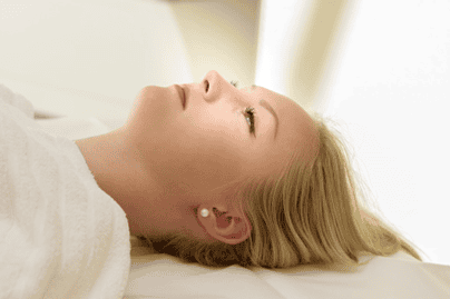 Image of a blonde-haired woman with glowing skin after receiving a cosmetic peel treatment.