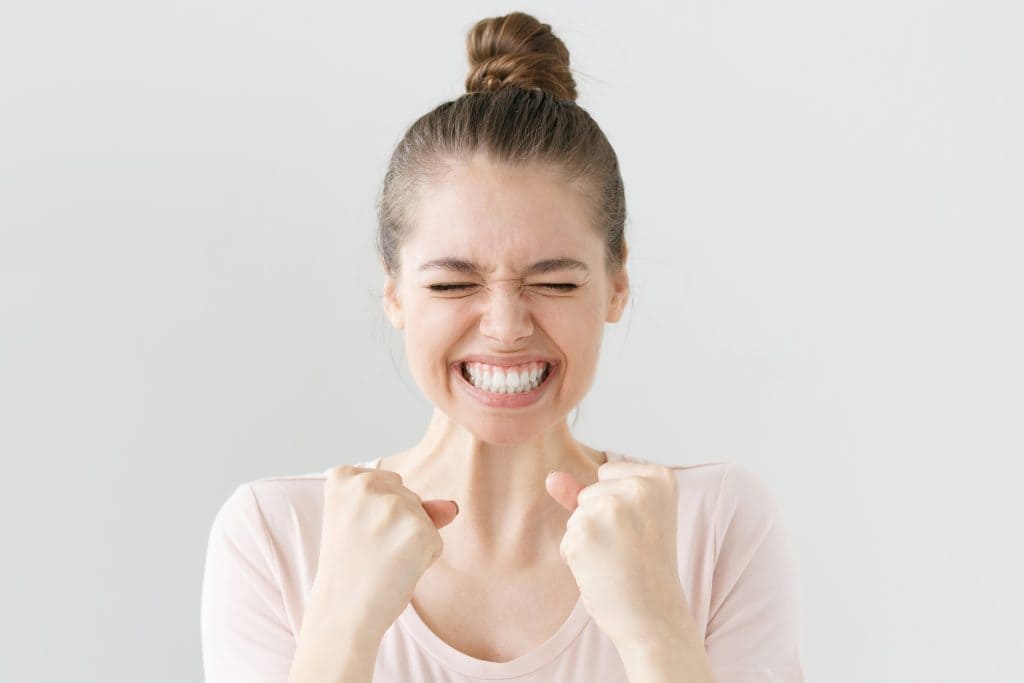 Woman smiling after hearing more membership program details.