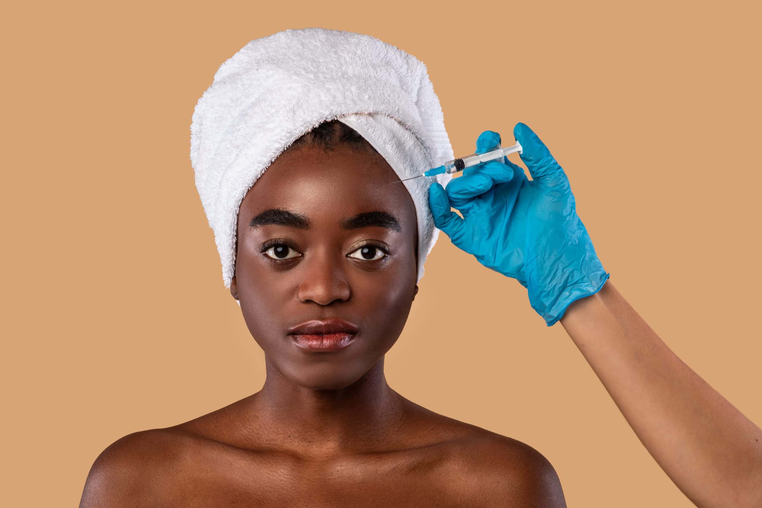 Women receiving a facial injectable treatment.