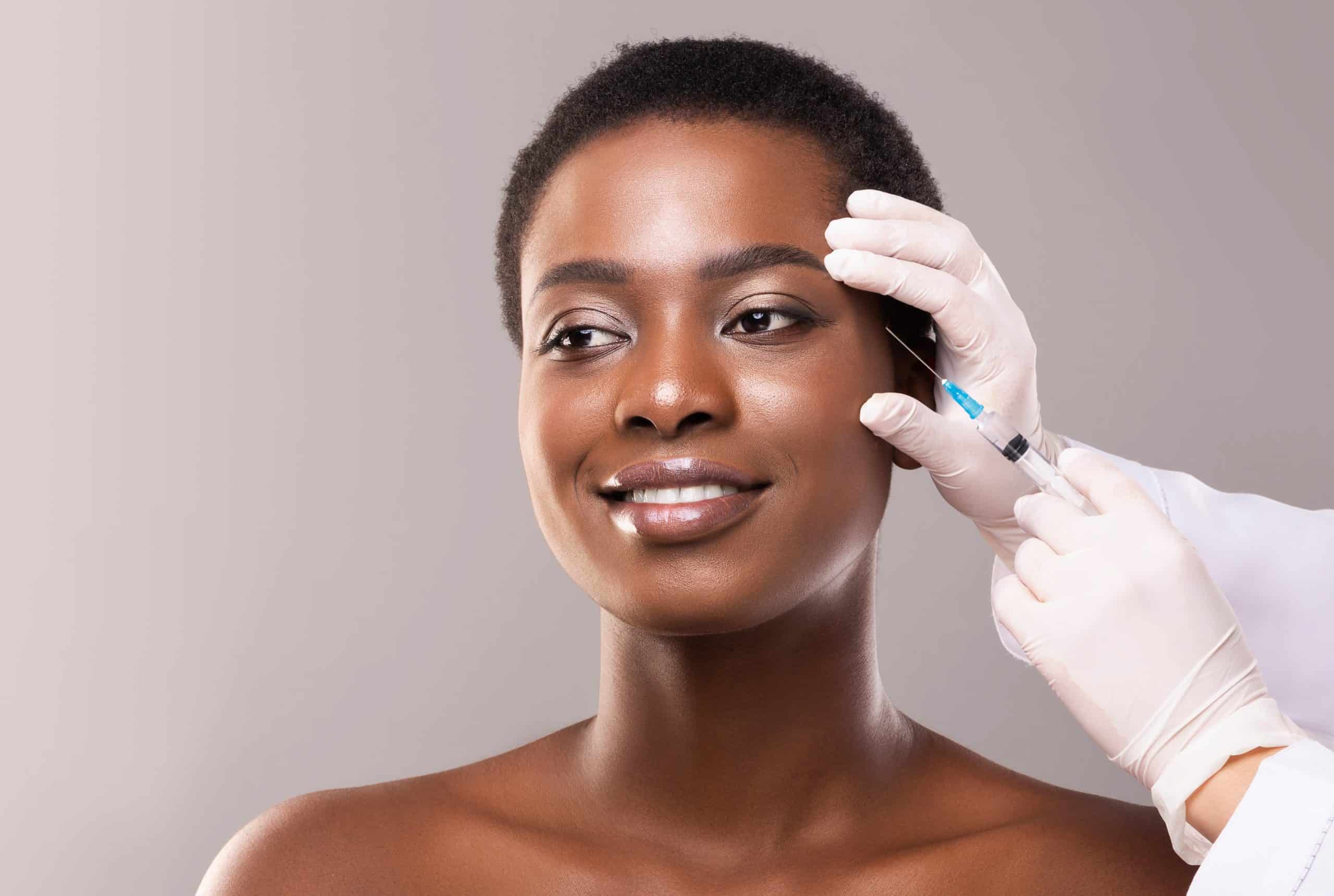Woman receiving PDO Thread Lift treatment on her forehead.