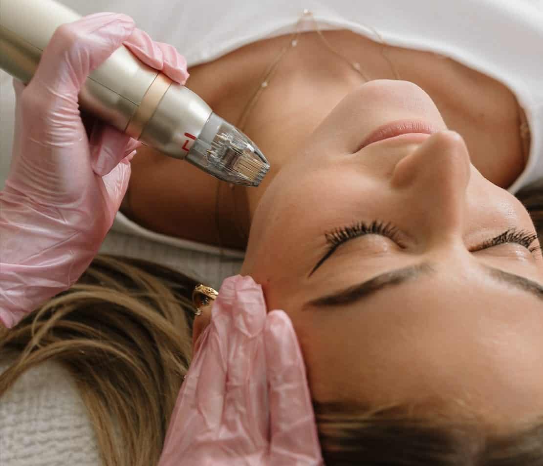 A young woman receiving facial treatments at a med spa